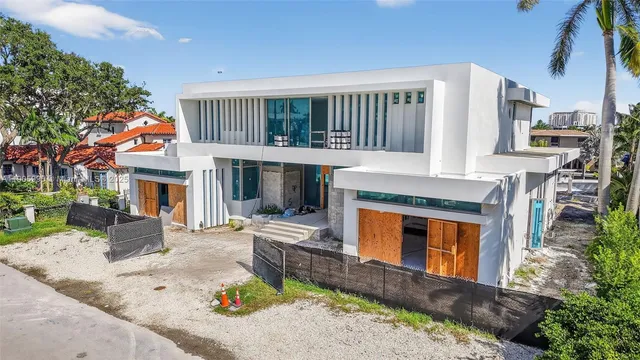 a view of a lake with boats and palm trees