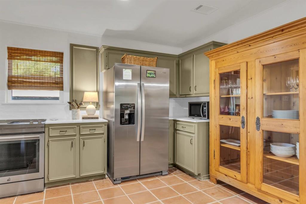 9780 North County Road Frisco, TX 75033 - Photo 12 of 36 a kitchen with stainless steel appliances granite countertop a refrigerator and a stove top oven