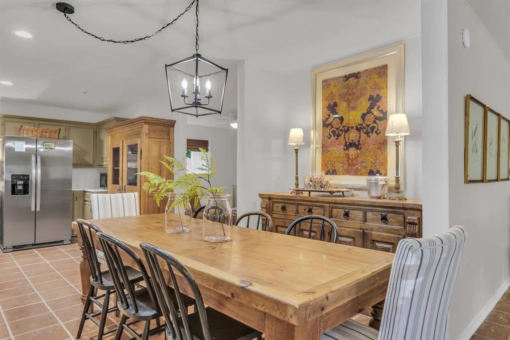 9780 North County Road Frisco, TX 75033 - Photo 13 of 36 a view of a dining room with furniture a chandelier and wooden floor