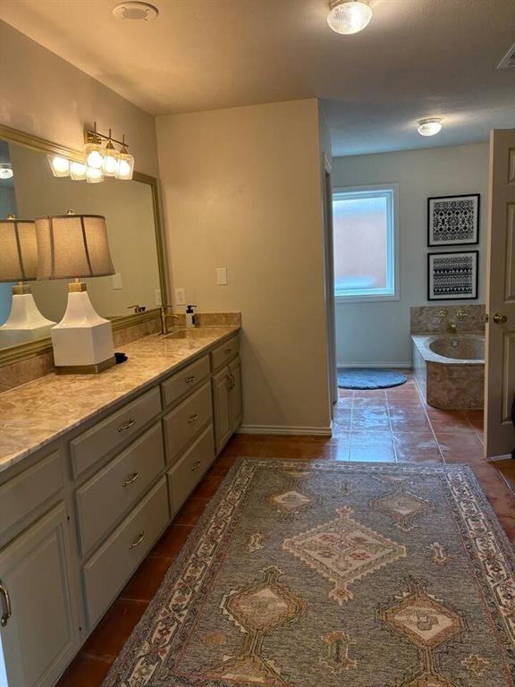 9780 North County Road Frisco, TX 75033 - Photo 28 of 36 a bathroom with a sink and a mirror