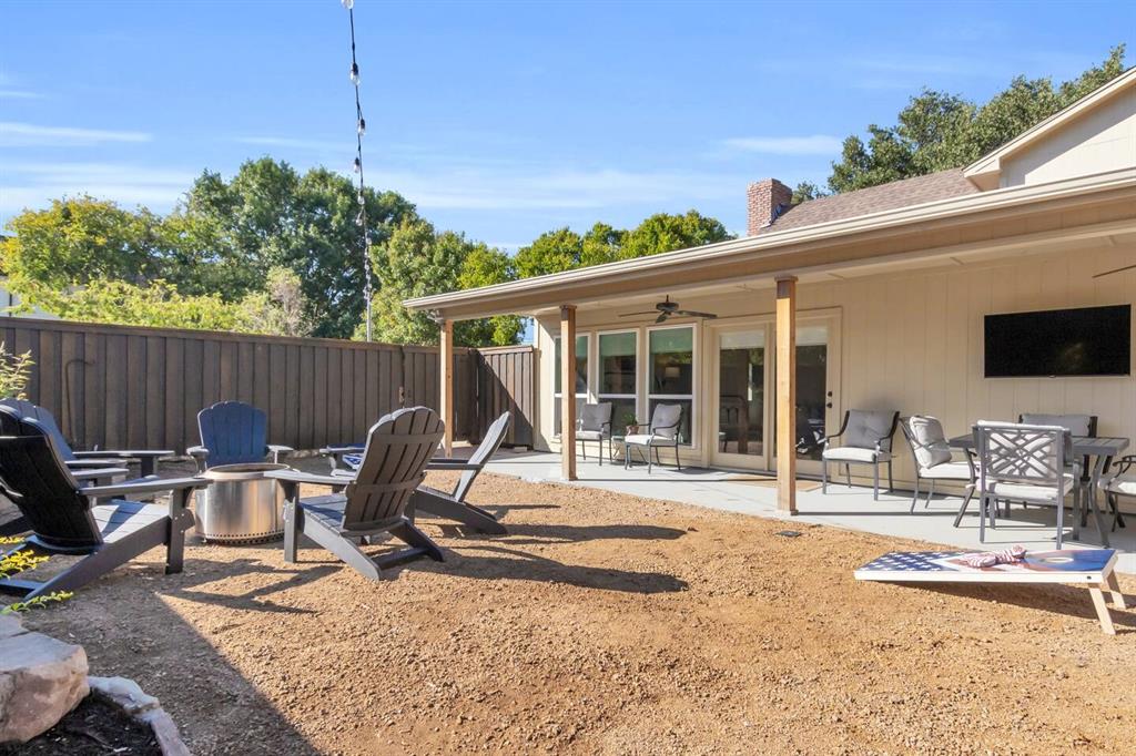 9780 North County Road Frisco, TX 75033 - Photo 33 of 36 a view of a backyard with table and chairs and wooden fence