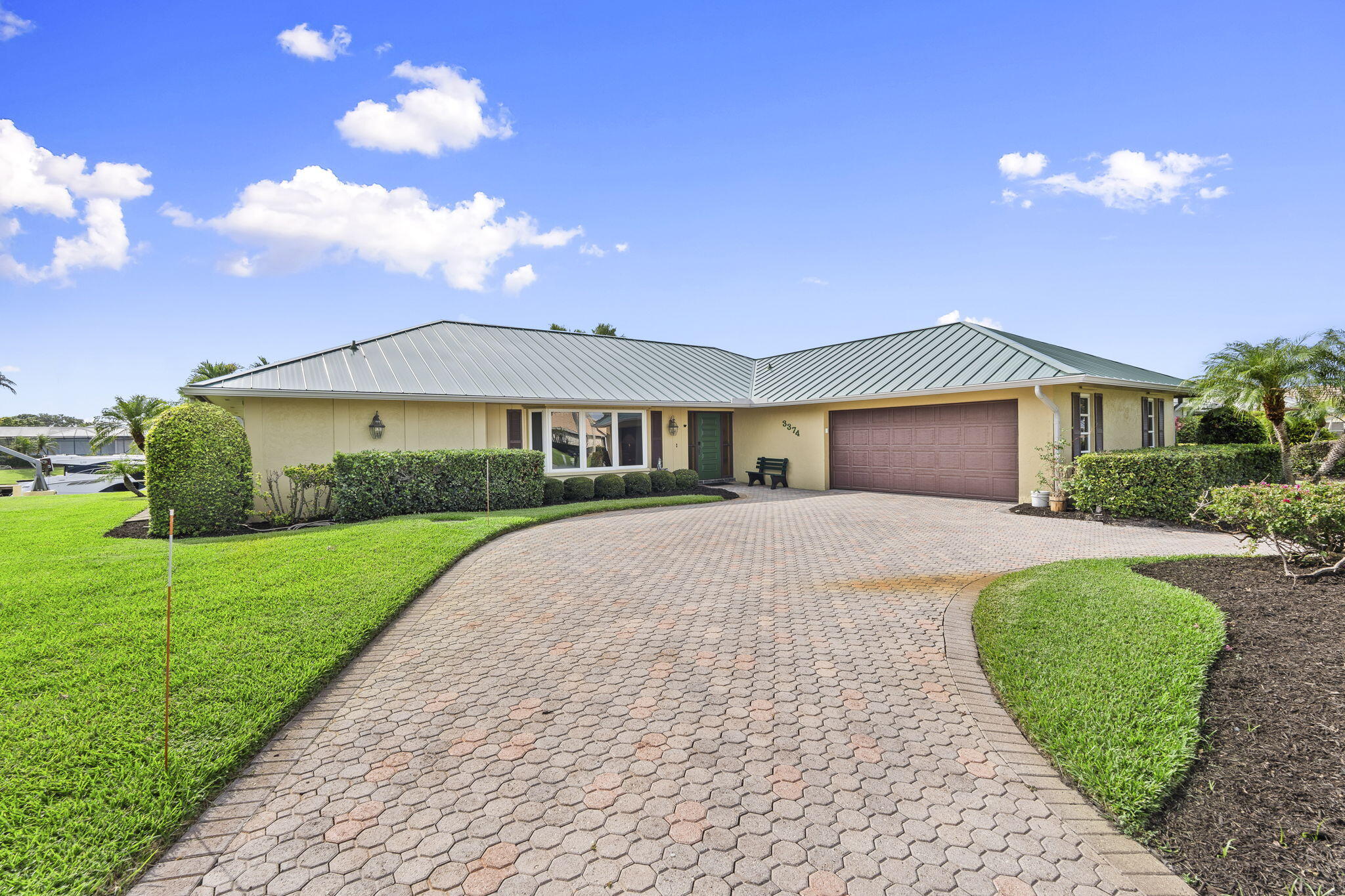 3374 Southeast Fairway East Stuart, FL 34997 - Photo 2 of 65 a front view of a house with a yard