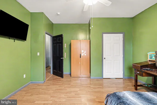 a bedroom with a bed and windows