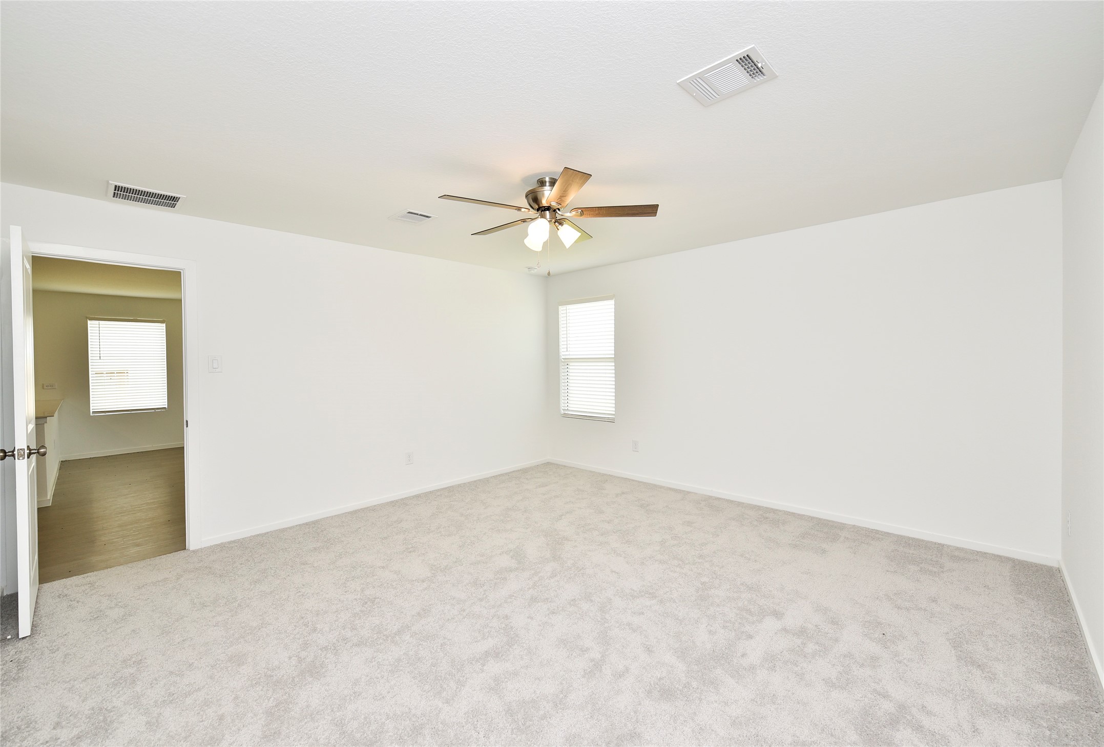 10218 Prairie Dunes Lane Cleveland, TX 77327 - Photo 17 of 32 an empty room with a window and a ceiling fan