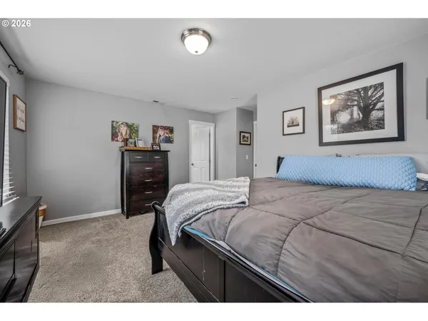 a bedroom with a bed and a desk