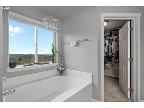 a bathroom with a tub sink and mirror