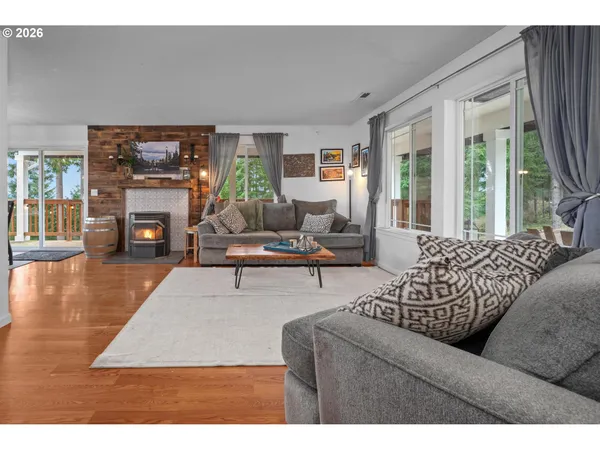 a living room with furniture large window and a fireplace