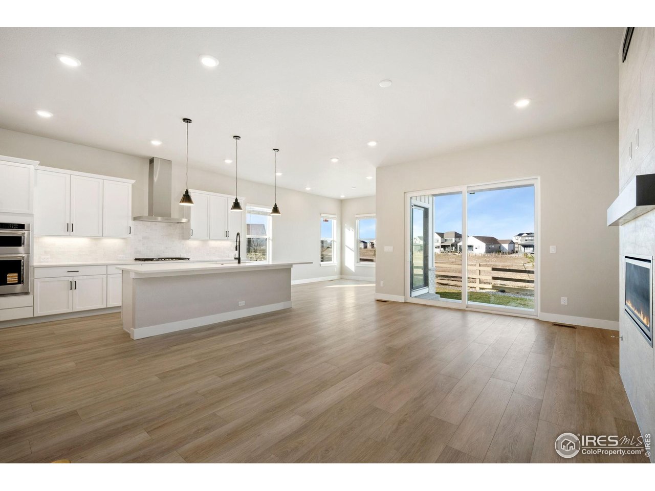 1426 Alyssa Drive Timnath, CO 80547 - Photo 11 of 15 a room with stainless steel appliances wooden floors and kitchen view