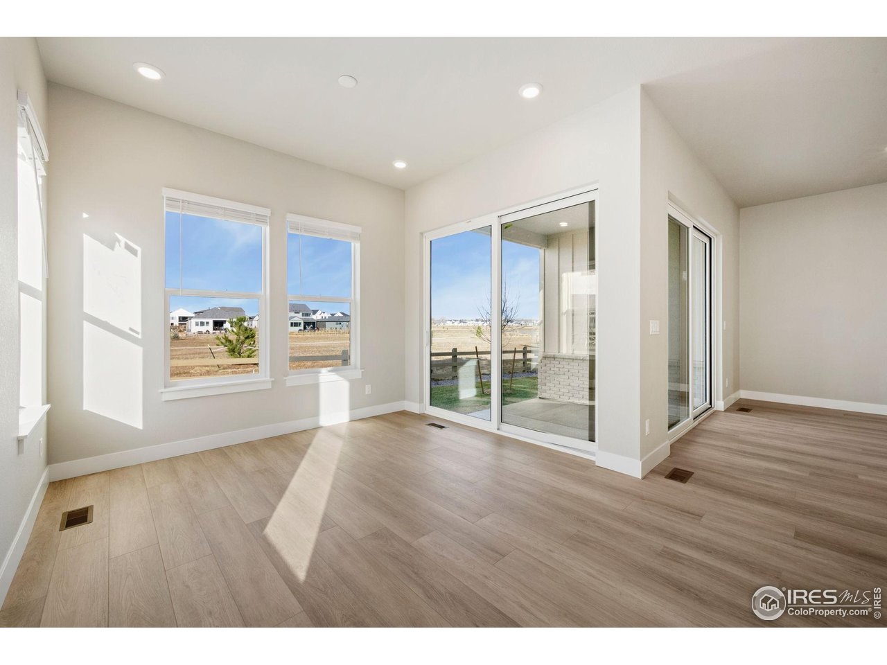 1426 Alyssa Drive Timnath, CO 80547 - Photo 5 of 15 a view of an empty room with wooden floor and a window