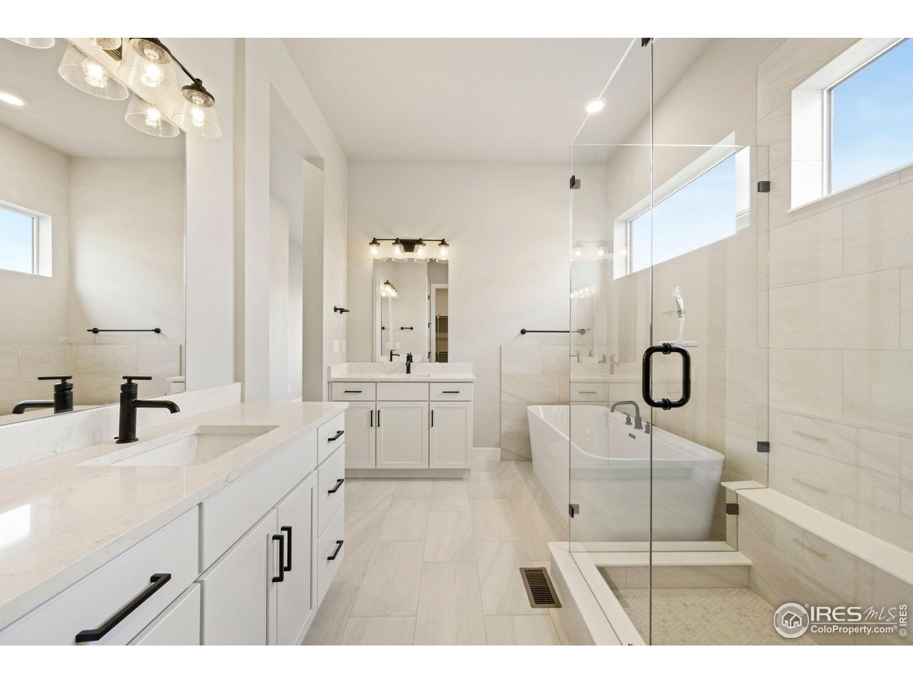 1426 Alyssa Drive Timnath, CO 80547 - Photo 7 of 15 a spacious bathroom with a double vanity sink a mirror and a bathtub