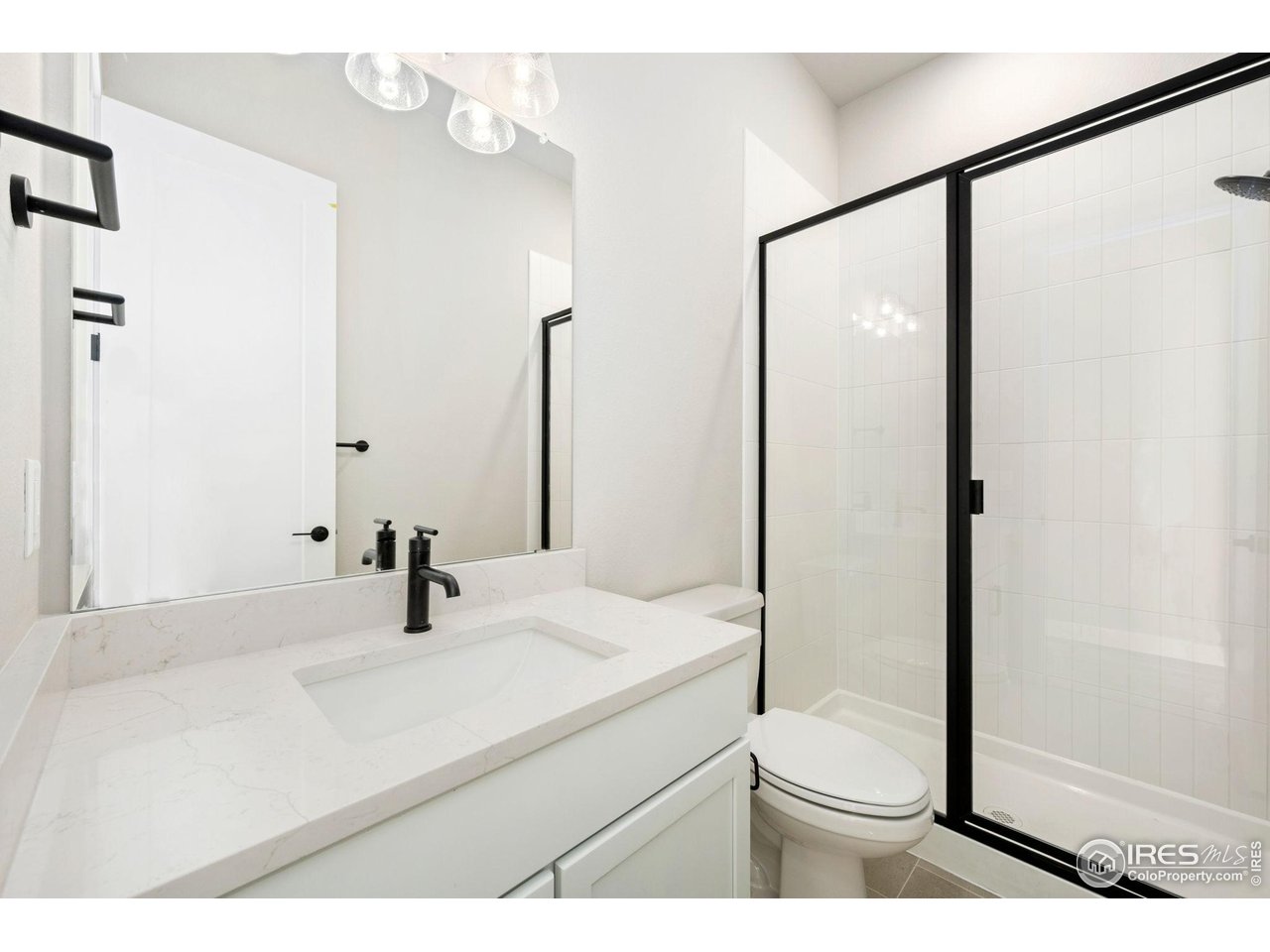 1426 Alyssa Drive Timnath, CO 80547 - Photo 9 of 15 a bathroom with a sink and a mirror with toilet