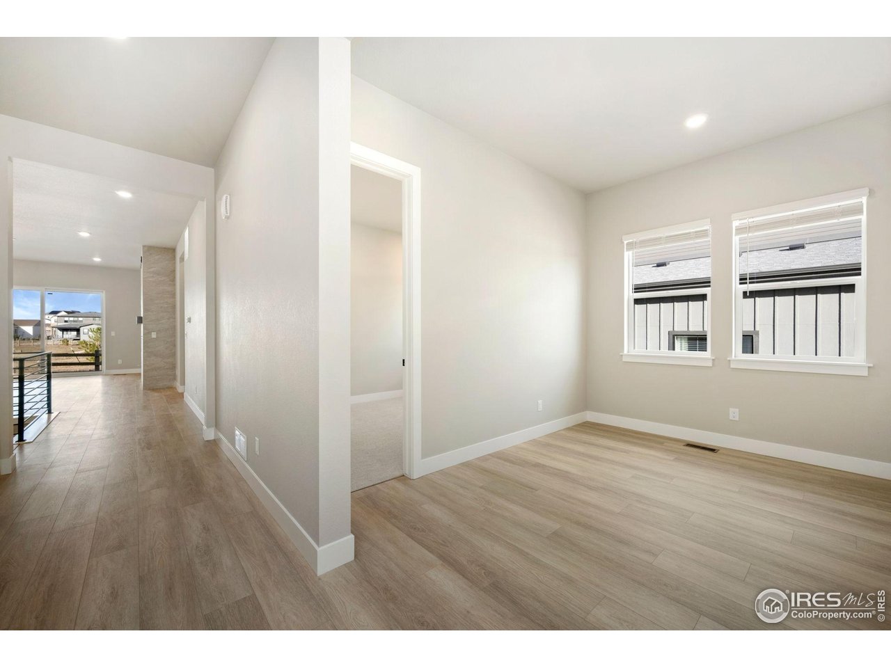 1426 Alyssa Drive Timnath, CO 80547 - Photo 10 of 15 a view of an empty room with wooden floor