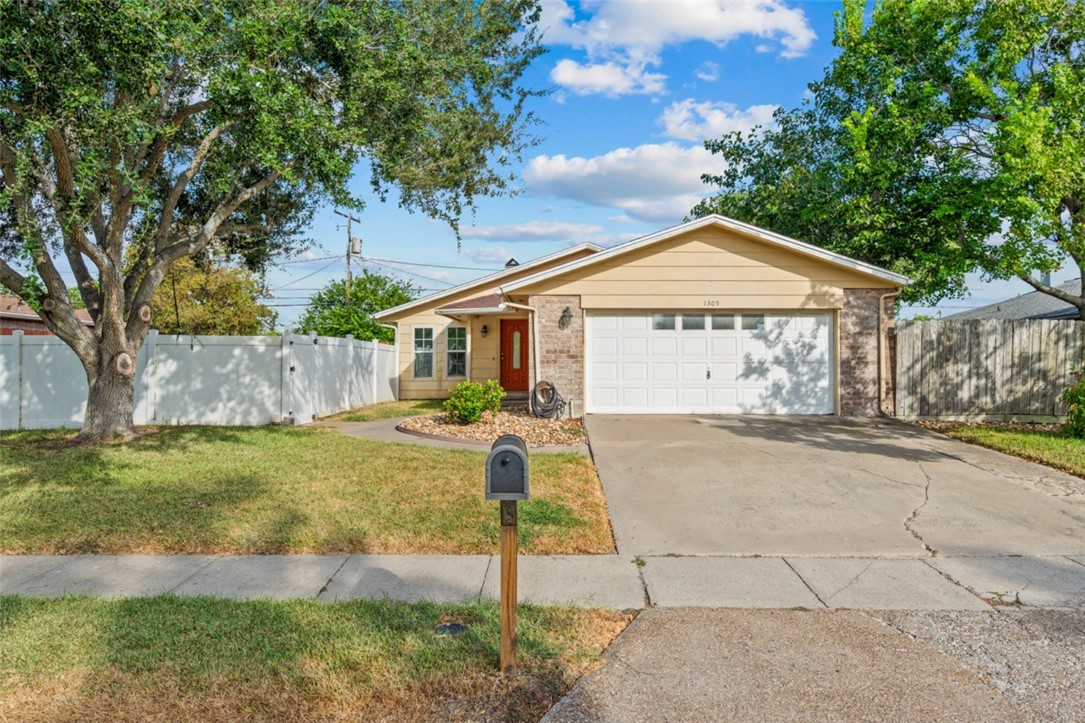1305 Harbor Lights Drive Corpus Christi, TX 78412 - Photo 1 of 31 a front view of a house with garden