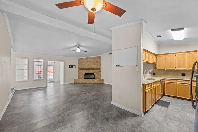 a large kitchen with cabinets and stainless steel appliances