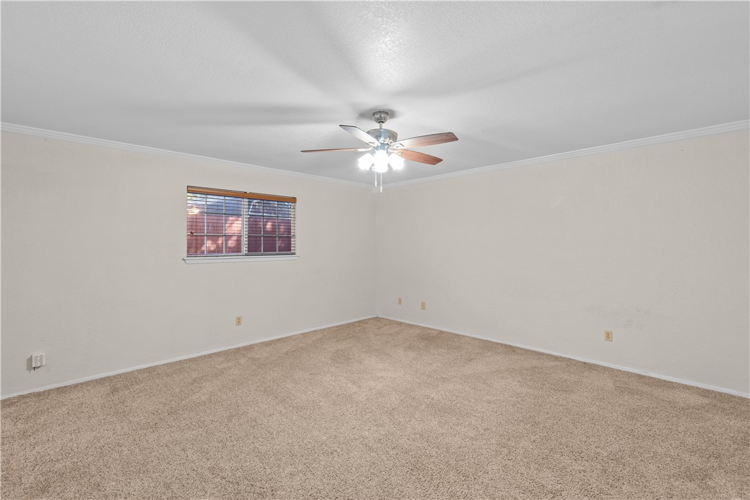 1305 Harbor Lights Drive Corpus Christi, TX 78412 - Photo 9 of 31 an empty room with a chandelier fan and windows