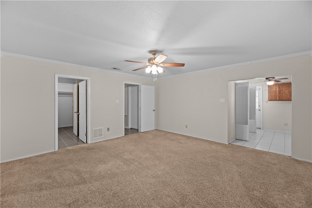 1305 Harbor Lights Drive Corpus Christi, TX 78412 - Photo 10 of 31 a view of an empty room with a ceiling fan
