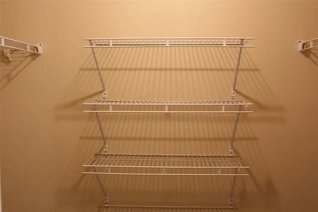 a bathroom with a granite countertop toilet and sink