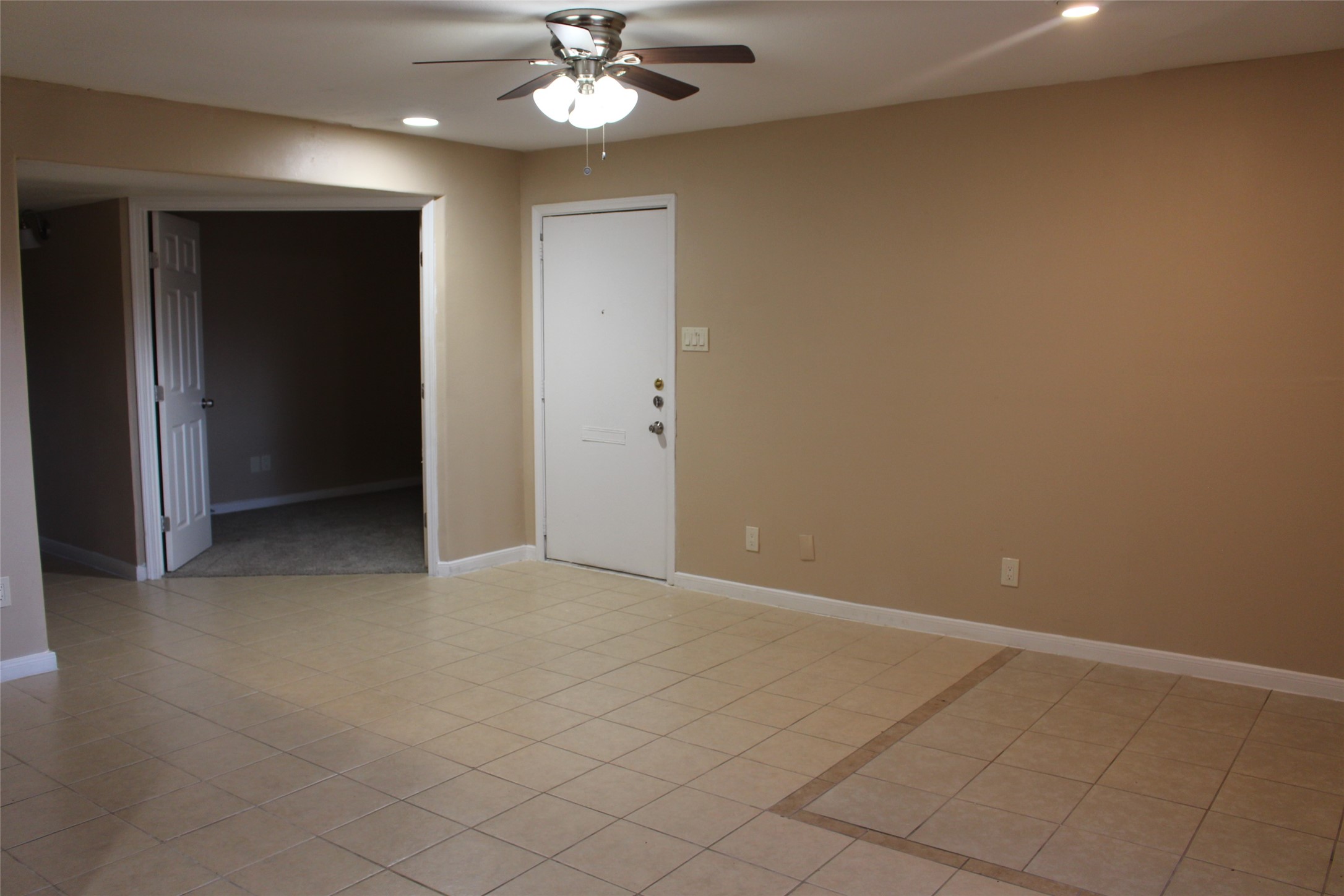 16111 Aspenglenn Drive, Unit 1001 Houston, TX 77084 - Photo 2 of 17 a view of an empty room with a chandelier fan