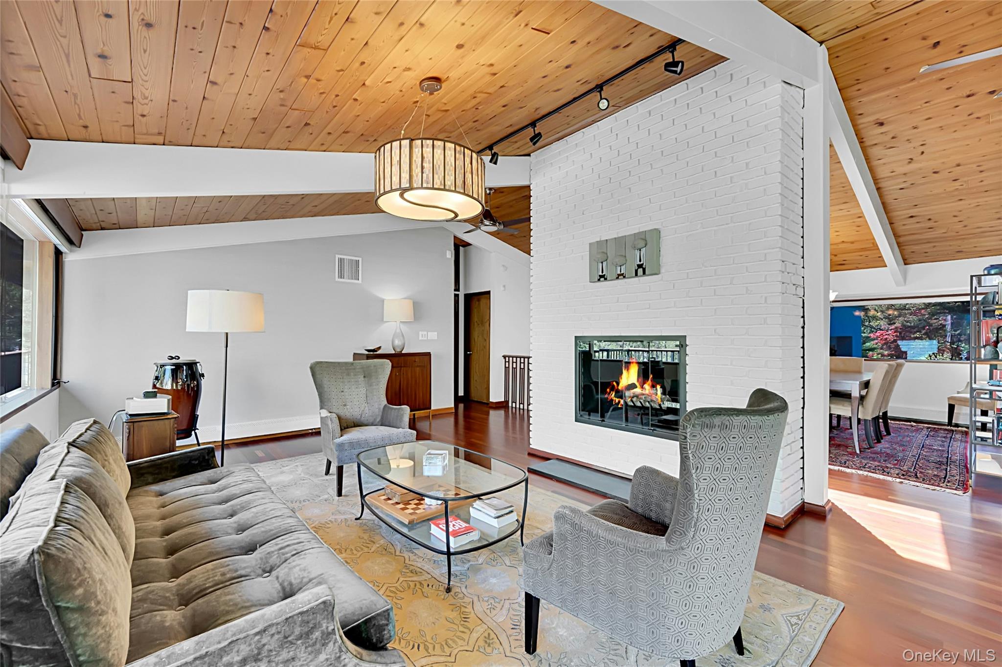 120 Kitchawan Road Pound Ridge, NY 10576 - Photo 11 of 40 a living room with furniture a flat screen tv and a fireplace