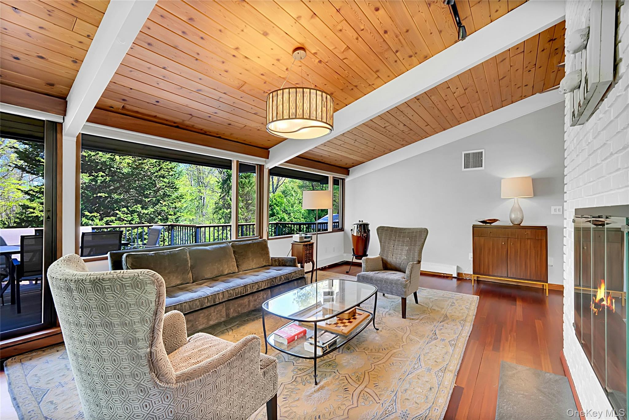 120 Kitchawan Road Pound Ridge, NY 10576 - Photo 12 of 40 a living room with furniture a fireplace and large windows