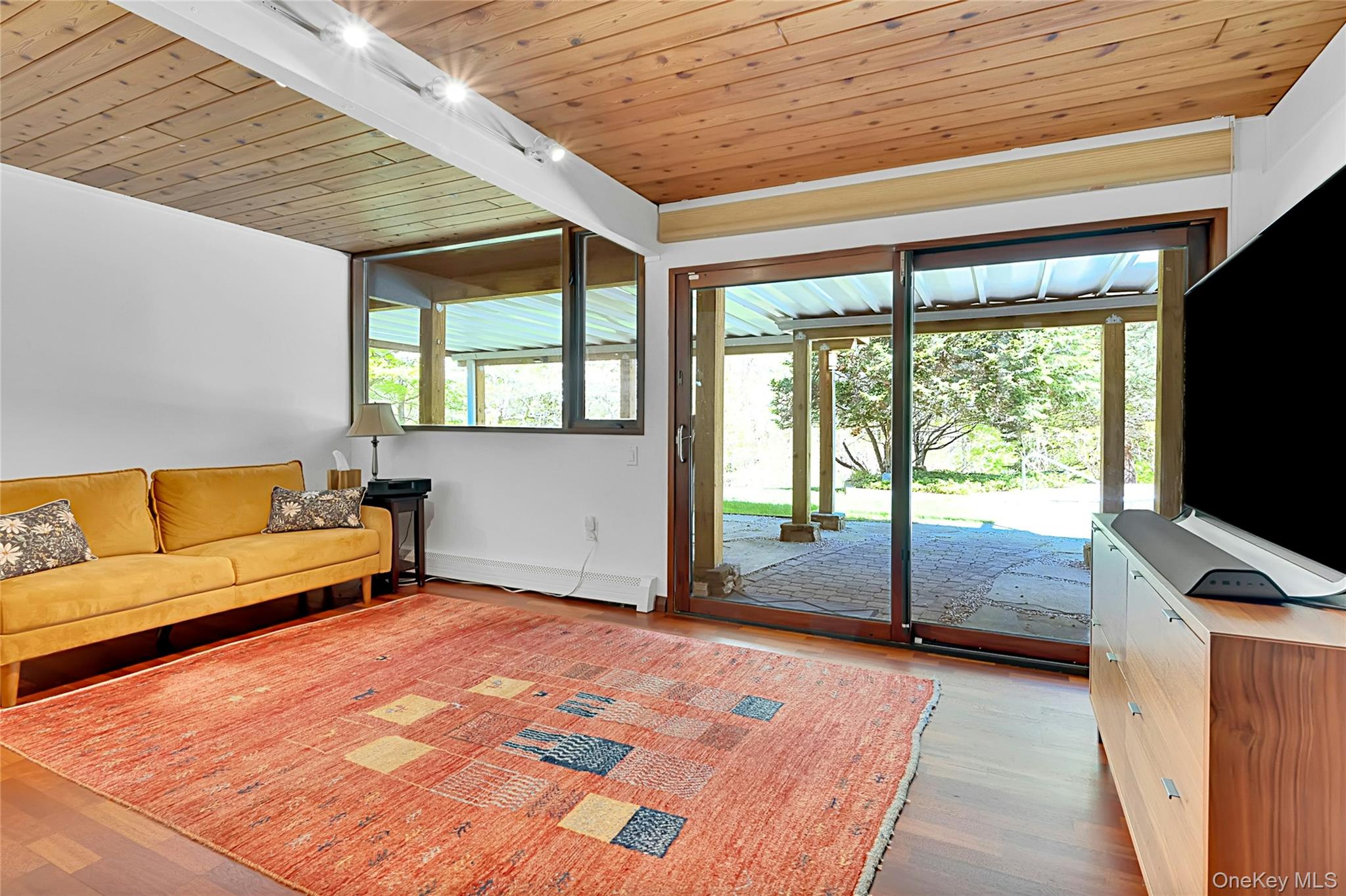 120 Kitchawan Road Pound Ridge, NY 10576 - Photo 26 of 40 a bedroom with furniture and large windows