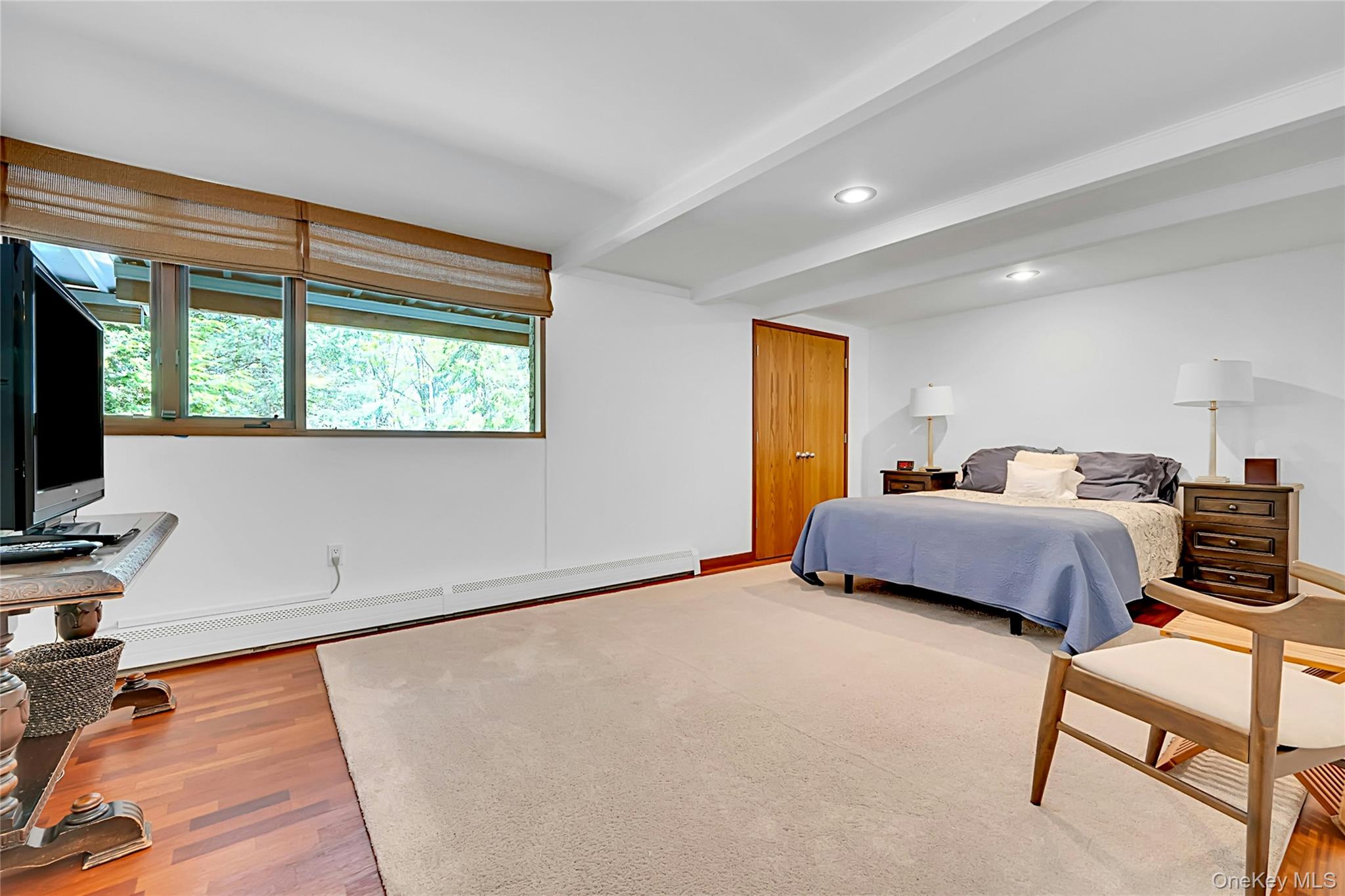 120 Kitchawan Road Pound Ridge, NY 10576 - Photo 28 of 40 a bedroom with a bed and a flat screen tv