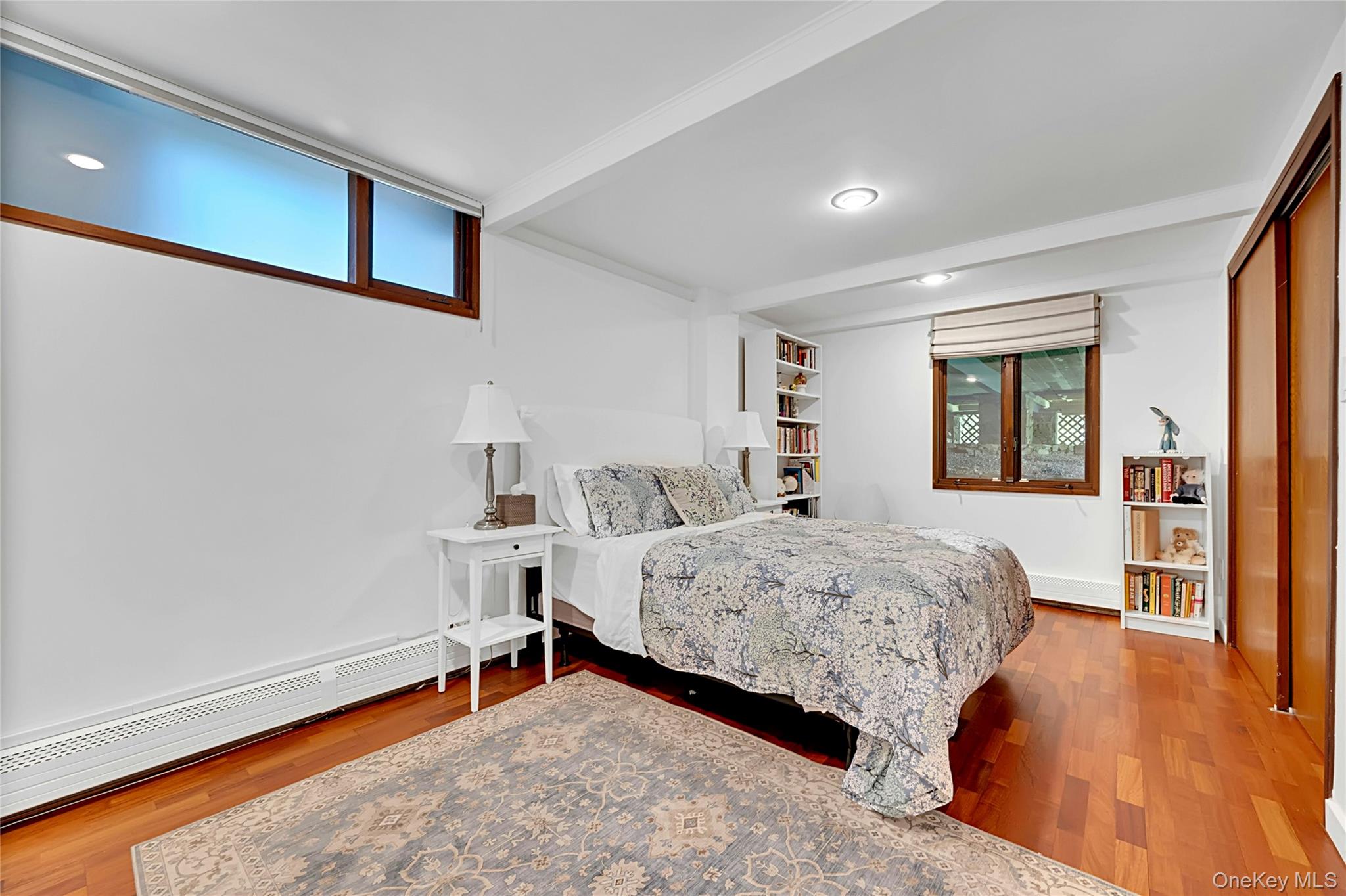 120 Kitchawan Road Pound Ridge, NY 10576 - Photo 30 of 40 a bedroom with a bed and wooden floor