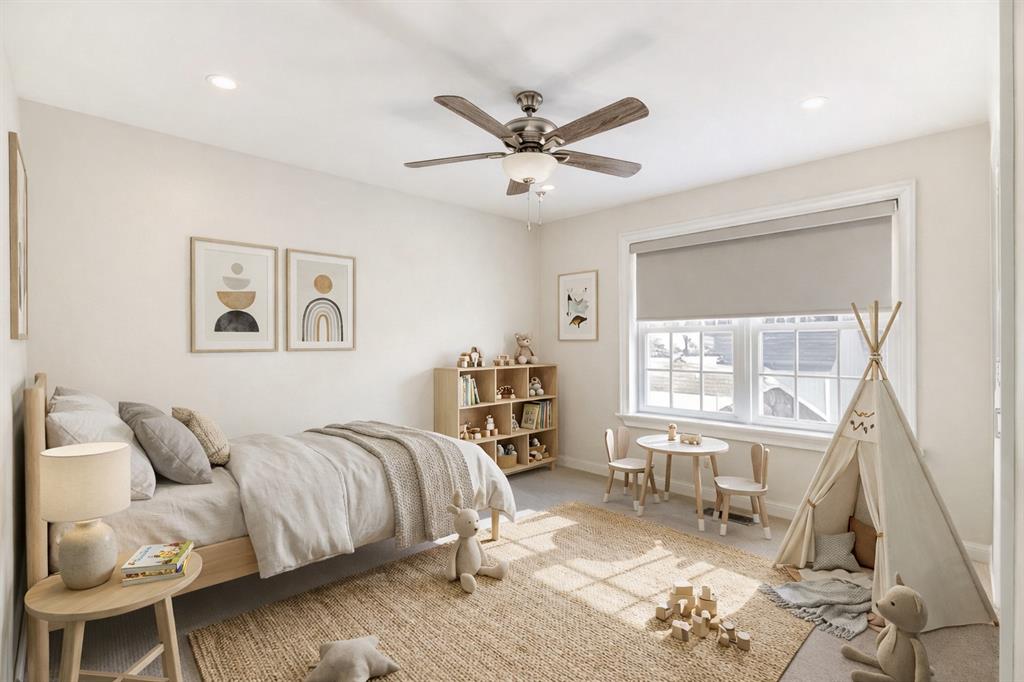 5123 Milam Street Dallas, TX 75206 - Photo 13 of 40 a spacious bedroom with a bed a couch and a window