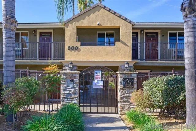 a front view of a house with glass windows and garage