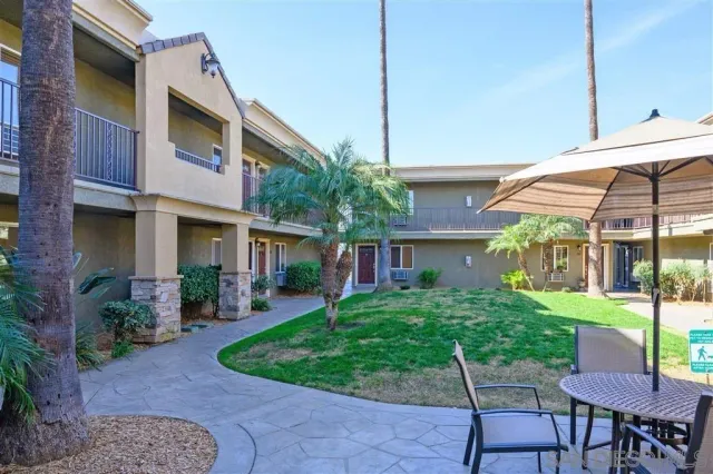 a view of house with a yard
