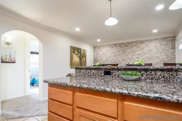 a kitchen with kitchen island granite countertop sink and a granite counter tops