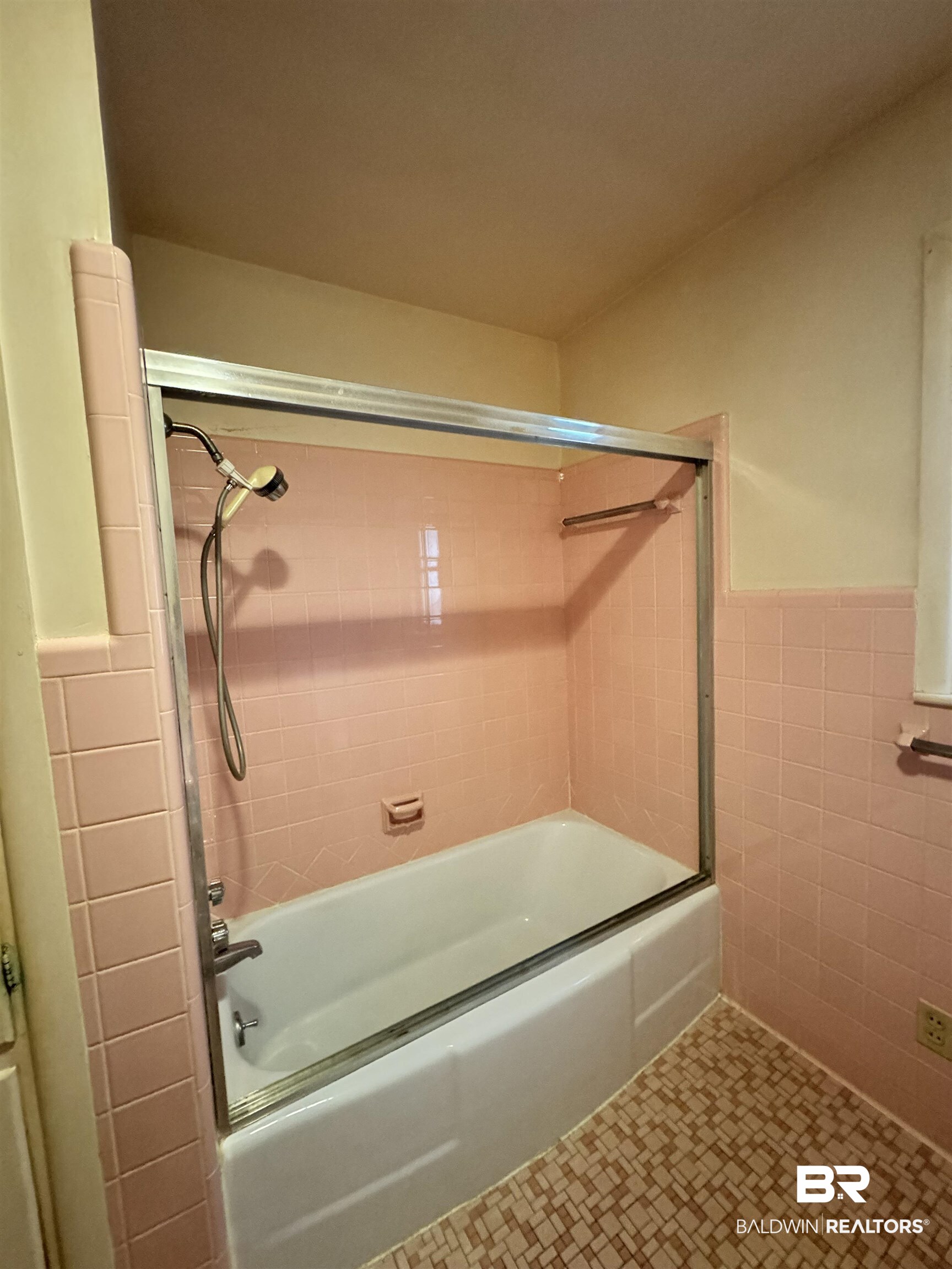 217 West Magnolia Avenue Foley, AL 36535 - Photo 16 of 21 Bathroom featuring tile walls, tiled shower / bath combo, and tile patterned floors