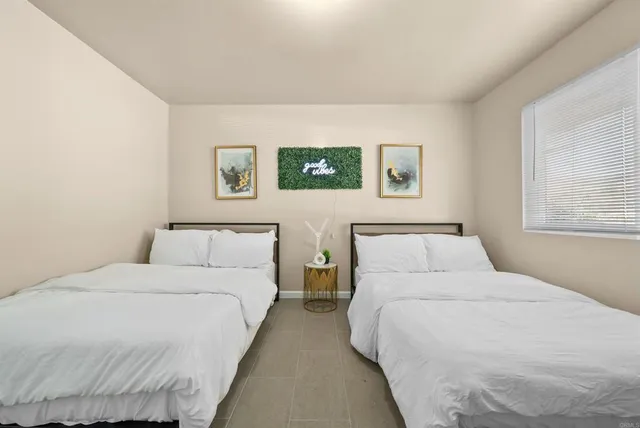 a bedroom with bed and a window