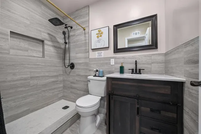 a bathroom with a sink a toilet and shower