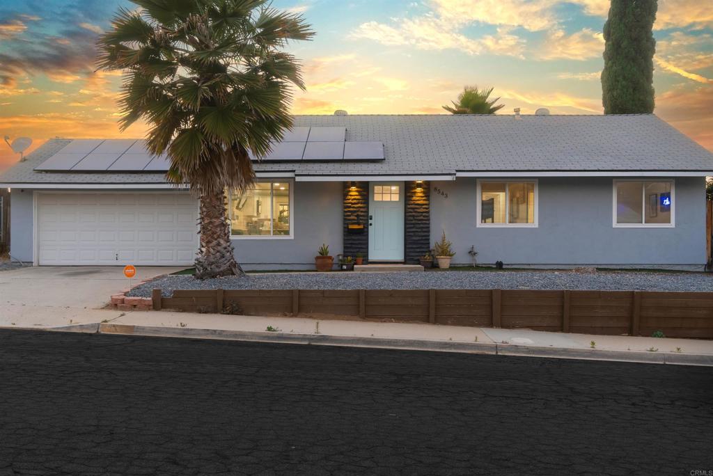 8543 Via Consuelo El Cajon, CA 92021 - Photo 35 of 51 a front view of a house with a garden and yard