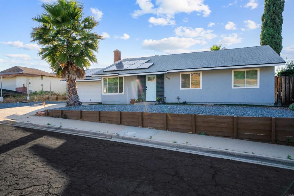 8543 Via Consuelo El Cajon, CA 92021 - Photo 47 of 51 a front view of a house with a yard
