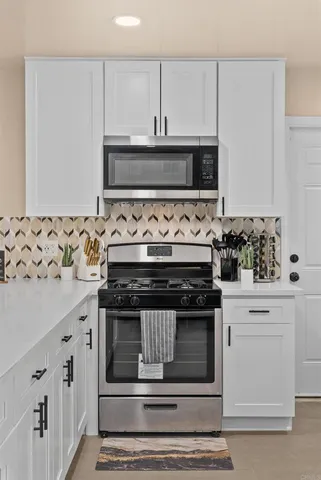 a stove top oven sitting inside of a kitchen