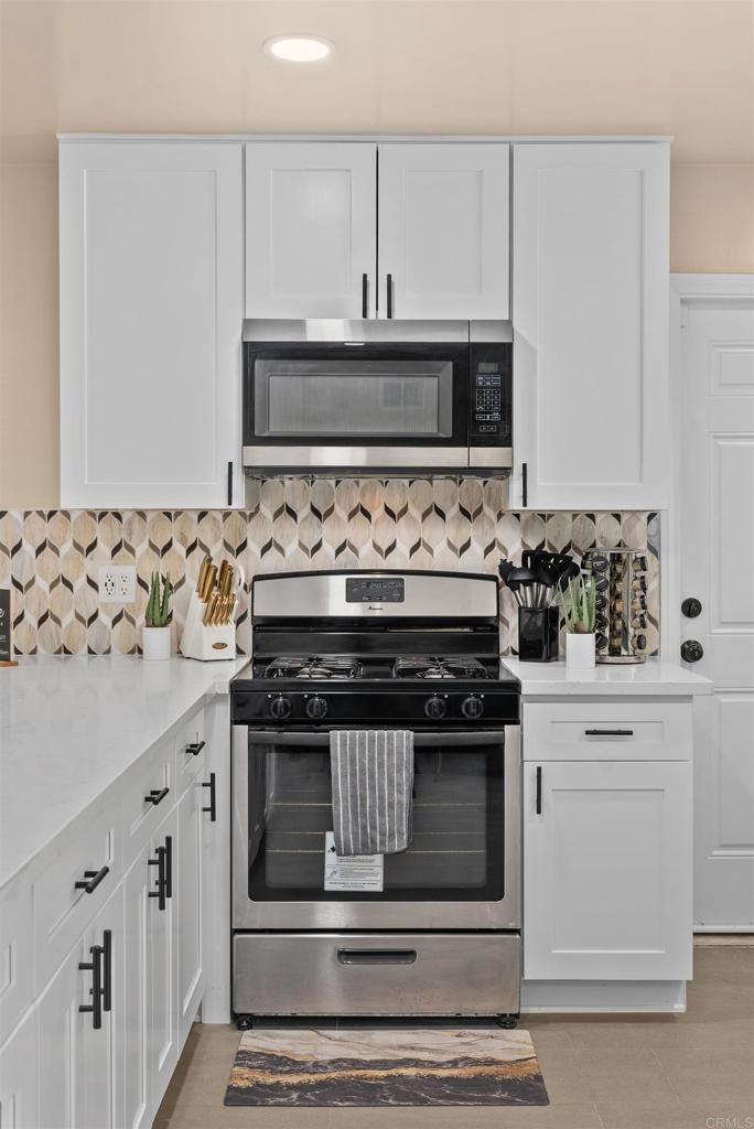 8543 Via Consuelo El Cajon, CA 92021 - Photo 10 of 51 a stove top oven sitting inside of a kitchen