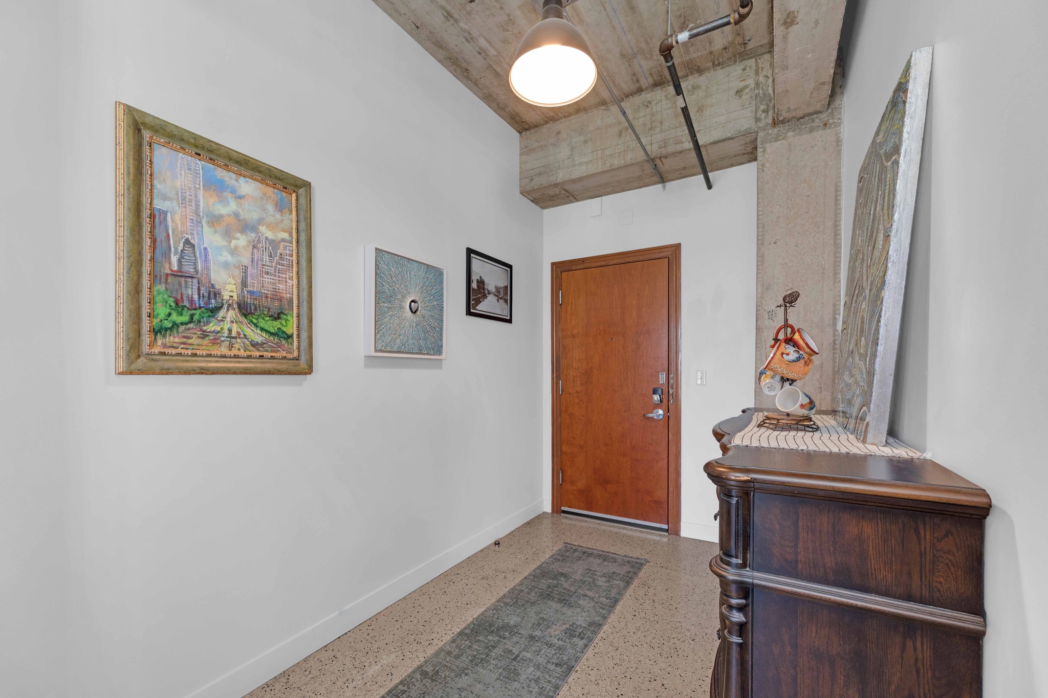 710 Colorado Street, Unit 8C Austin, TX 78701 - Photo 4 of 30 Entry foyer with high ceilings and concrete accents