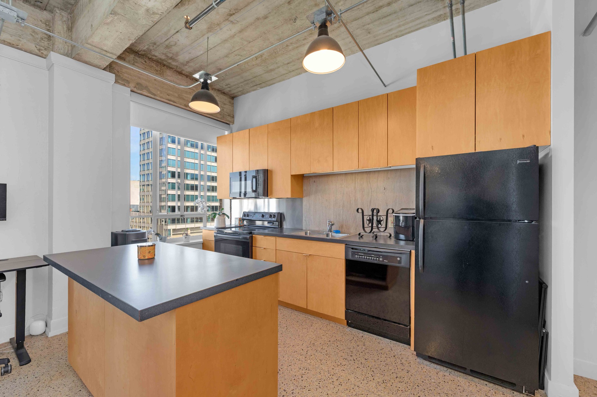 710 Colorado Street, Unit 8C Austin, TX 78701 - Photo 10 of 30 Kitchen with island seating and ample cabinetry