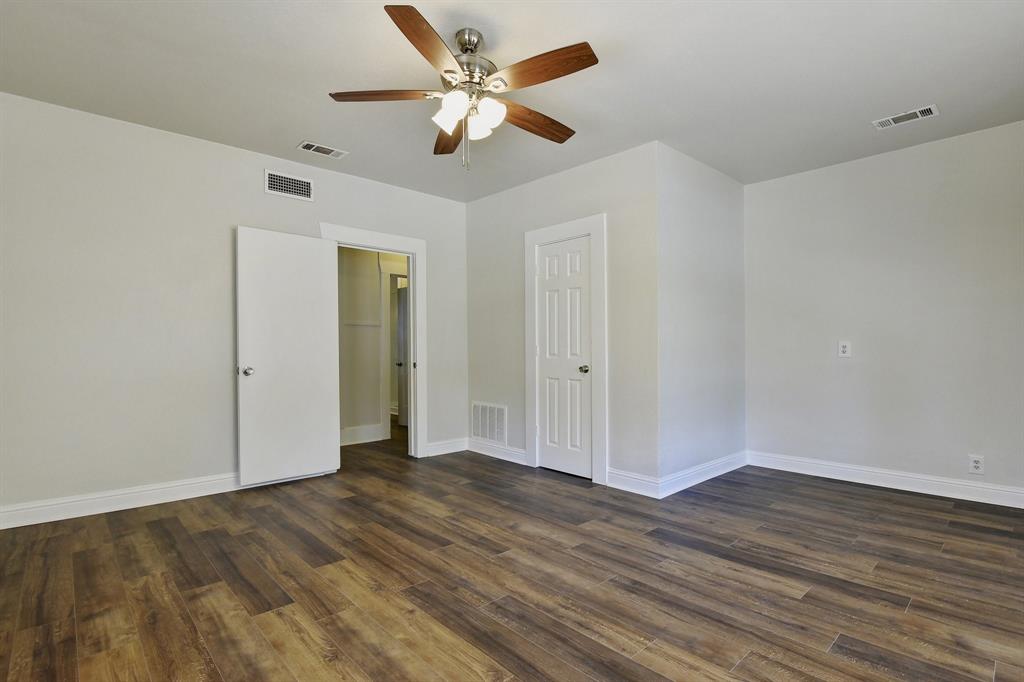 1115 South Rusk Avenue Denison, TX 75020 - Photo 15 of 21 a view of an empty room with wooden floor