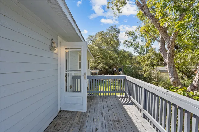 a view of balcony with wooden floor and fence
