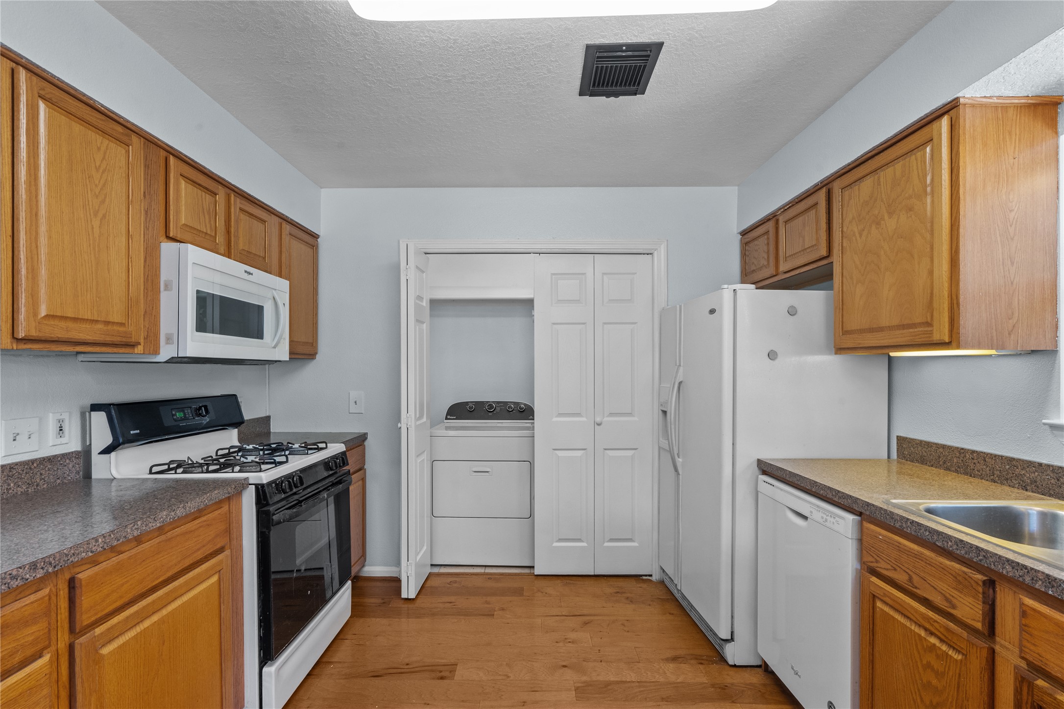 336 Reppert Street, Unit A Bacliff, TX 77518 - Photo 12 of 17 a kitchen with stainless steel appliances a stove a sink and a refrigerator