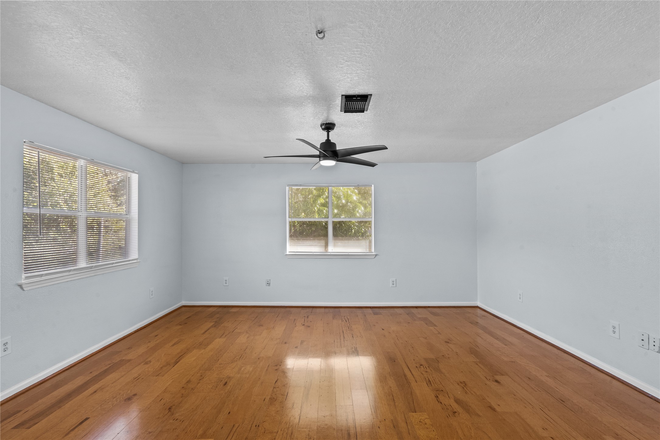 336 Reppert Street, Unit A Bacliff, TX 77518 - Photo 13 of 17 a big room with wooden floor a chandelier fan and windows