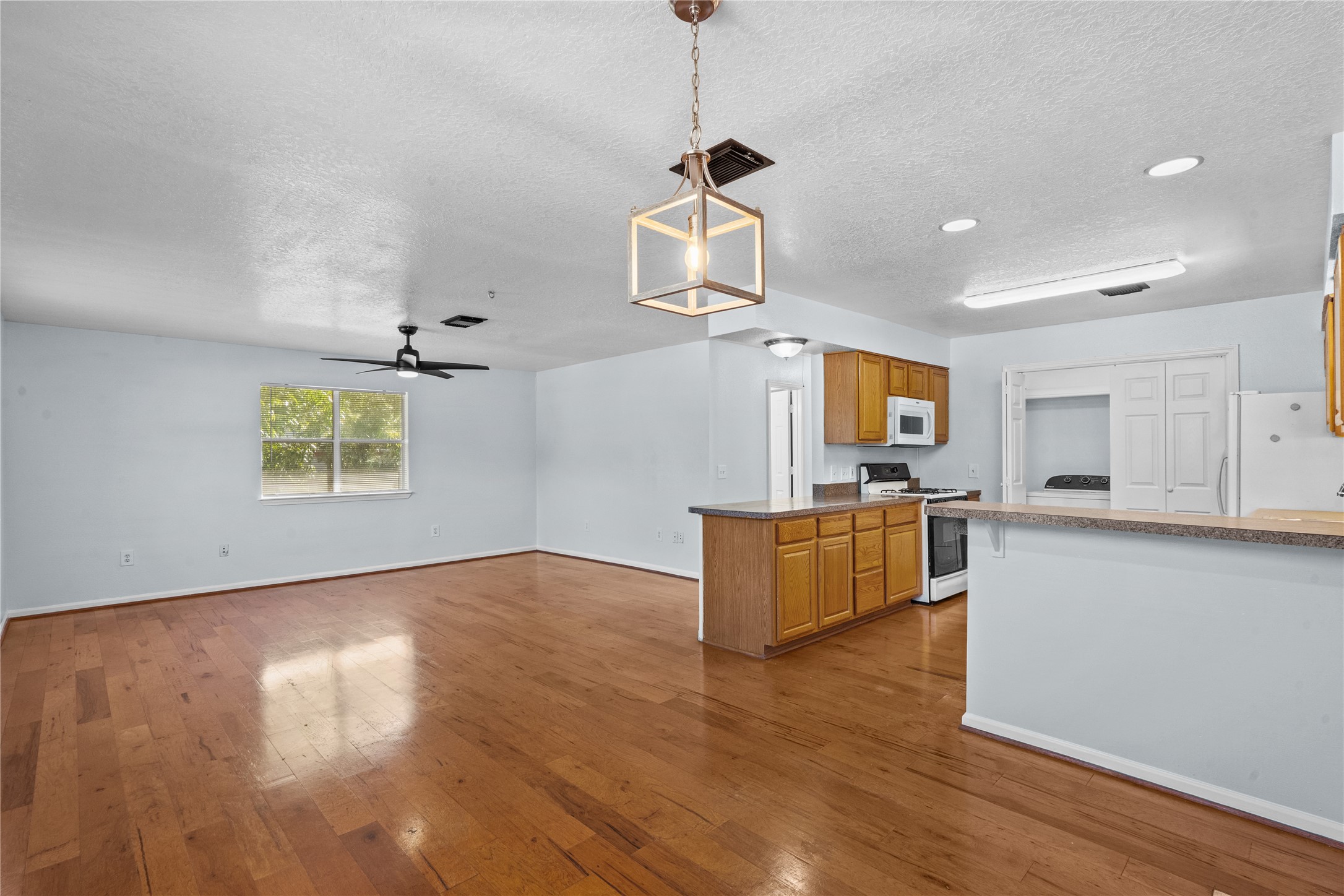 336 Reppert Street, Unit A Bacliff, TX 77518 - Photo 16 of 17 a view of kitchen and wooden floor