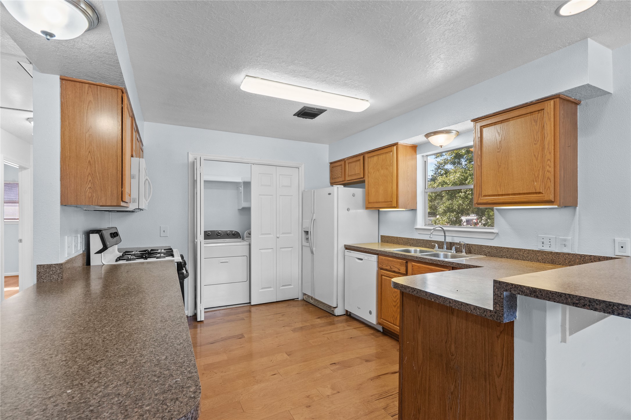 336 Reppert Street, Unit A Bacliff, TX 77518 - Photo 5 of 17 a kitchen with a sink stove and refrigerator