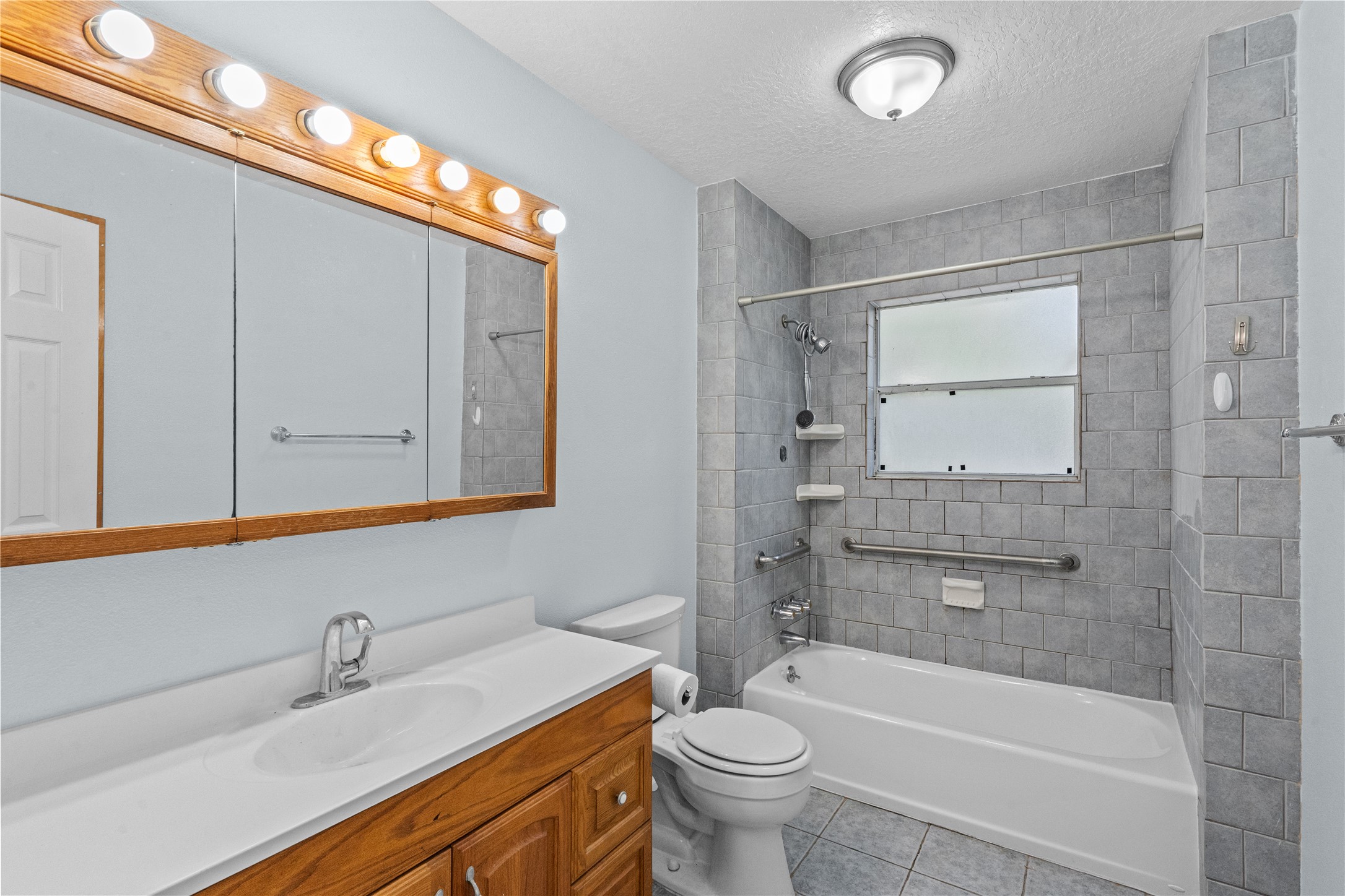 336 Reppert Street, Unit A Bacliff, TX 77518 - Photo 8 of 17 a bathroom with a sink a toilet and shower