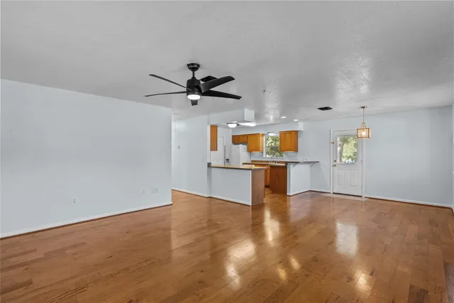 a view of an empty room with a kitchen