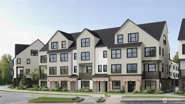 a front view of a residential apartment building with a yard