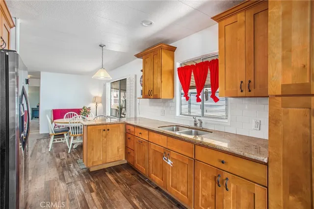 a kitchen with stainless steel appliances granite countertop a stove refrigerator and a microwave